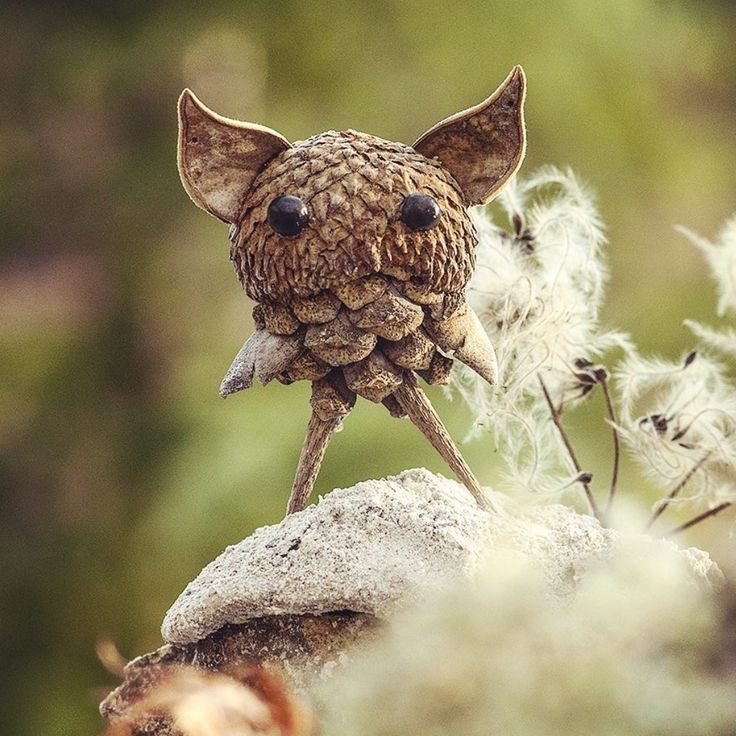 a small toy animal sitting on top of a rock