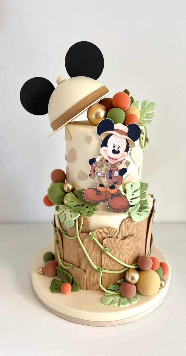 a mickey mouse cake is decorated with colorful decorations