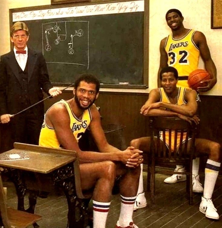 the basketball players are posing for a photo in front of the chalkboard with their coach