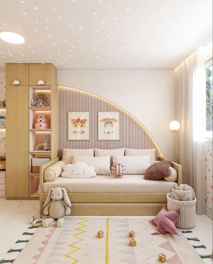 a child's bedroom is decorated in pastel tones and soft furnishings, including toys