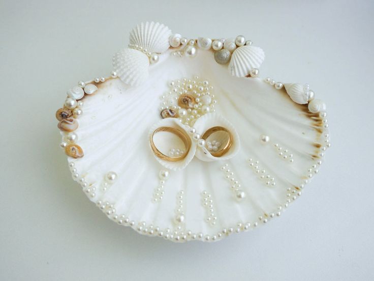 "This romantic Sea Shell Ring Holder is decorated with pearl beads and natural seashells. This ring holder is  4,6\" (11.5 сm.) and is perfect for your beach wedding.  Rings are not included.  Here you can see our offer for sea bridal belt: https://www.etsy.com/listing/570543589/beach-wedding-sash-shell-bridal-sash?ref=shop_home_active_9&frs=1 https://www.etsy.com/listing/627502050/beach-wedding-sash-shell-bridal-sash?ref=unav_listing-same-5&cns=1 Customization is available: - Request personaliz Ring Bearer Beach Wedding, Shell Ring Bearer, Shell Ring Holder, Engagement Ring Platter, خواتم خطوبة, Seashell Ring, Wedding Ring Holder, Wedding Gift Pack, Wedding Ring Shapes