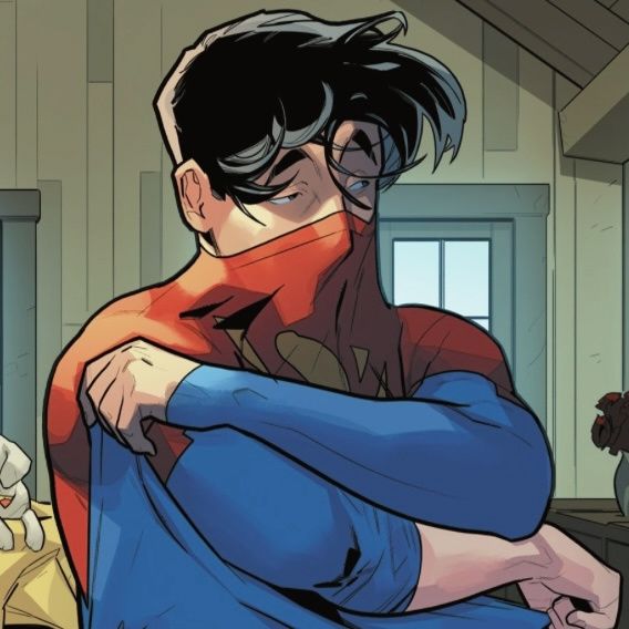 a man with glasses and a superman costume hugging another man in a room full of stuffed animals