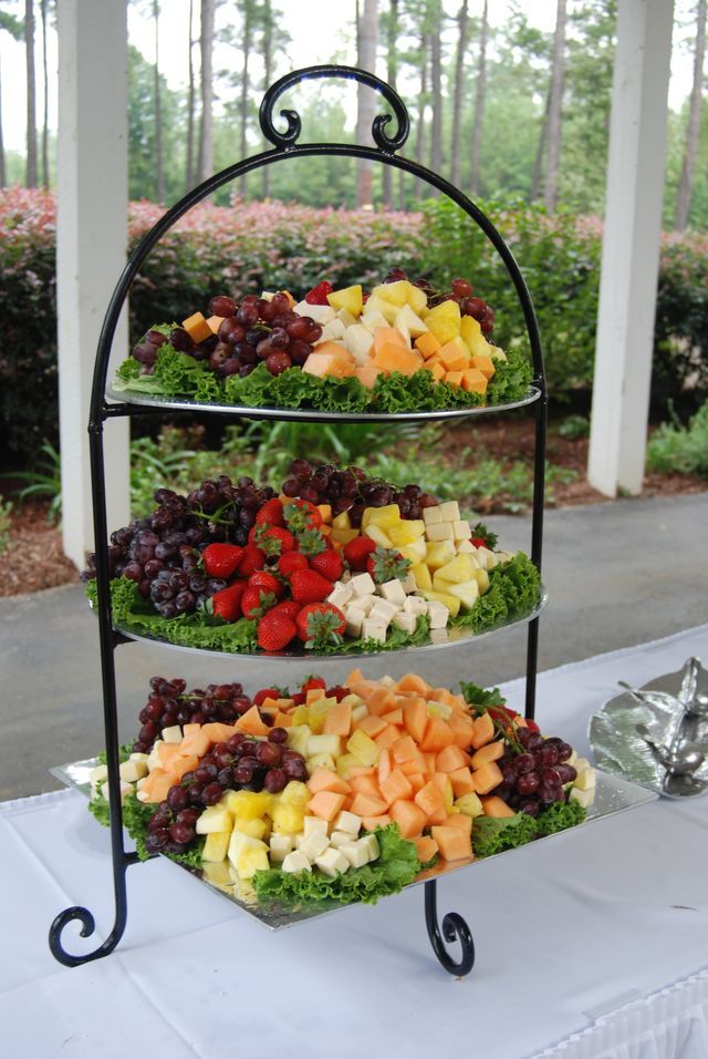 three tiered trays filled with fruits and vegetables