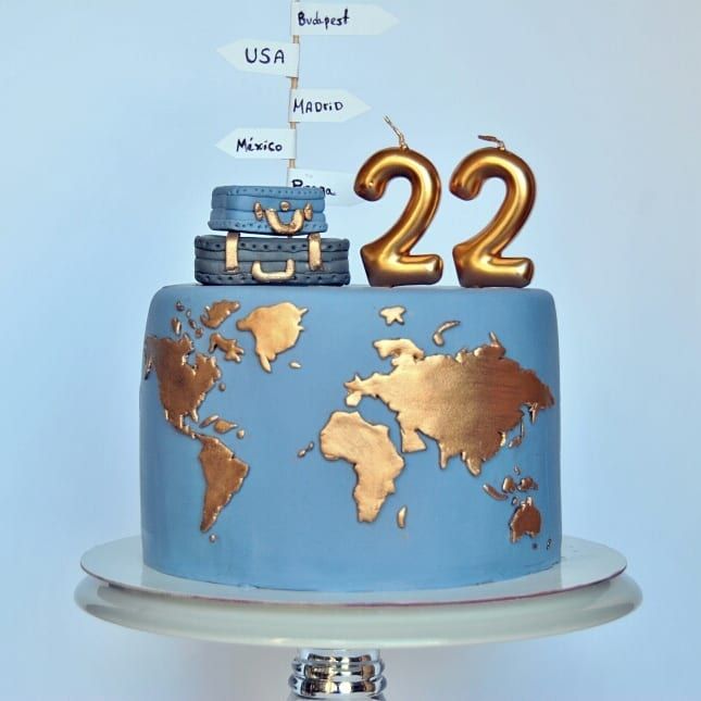 a blue and gold cake with the number twenty two on it's top tier