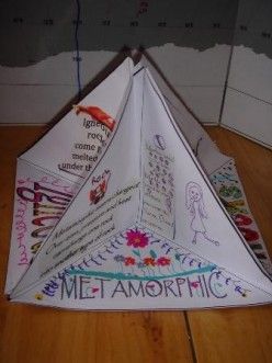 an origami kite with writing on it sitting on top of a wooden floor