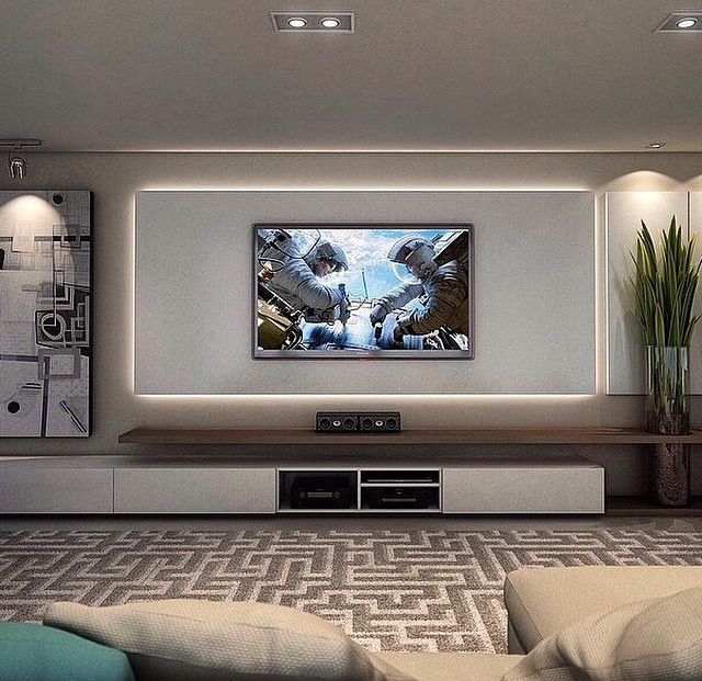 a large flat screen tv mounted to the wall in a living room