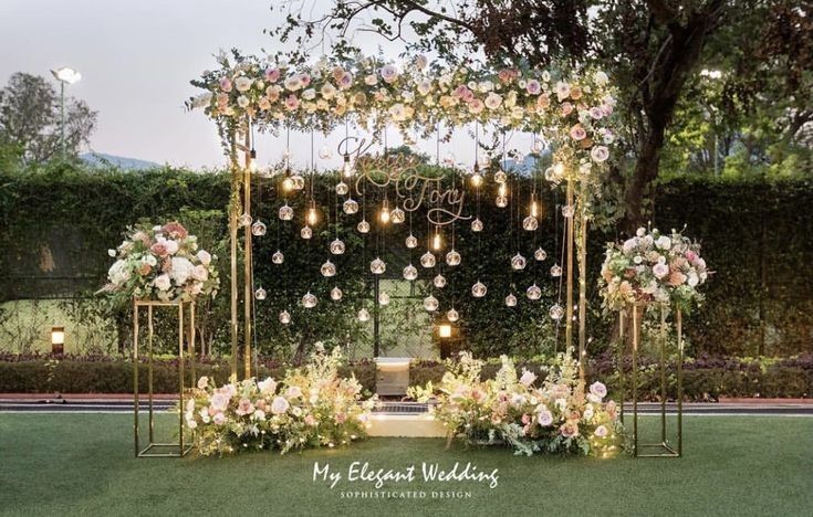 an outdoor ceremony setup with flowers and candles