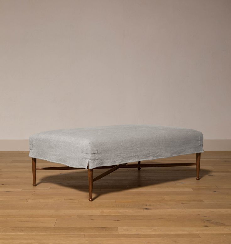 a blue ottoman sitting on top of a hard wood floor