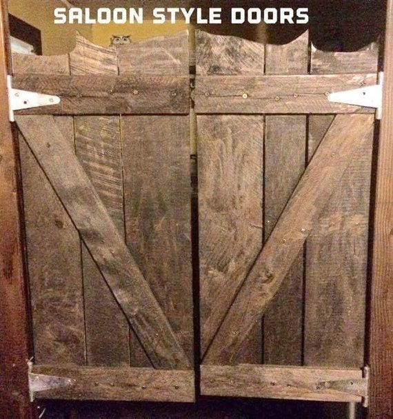 an old wooden door with the words saloon style doors on it's front side