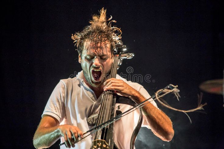 a man with dreadlocks on his face playing an instrument