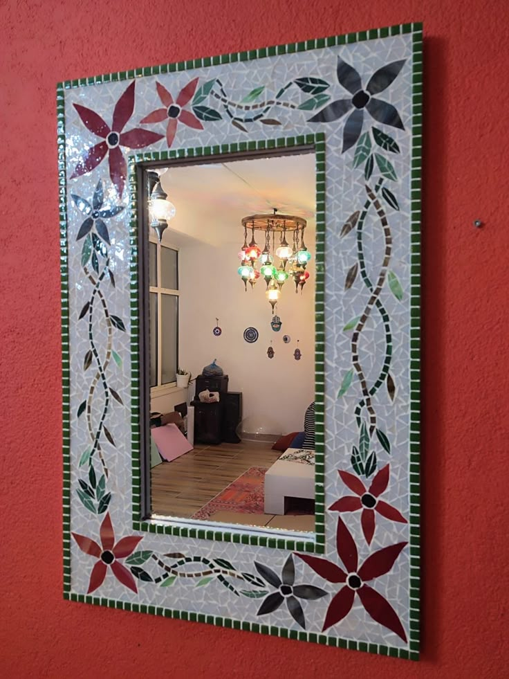 a decorative mirror mounted to the side of a wall