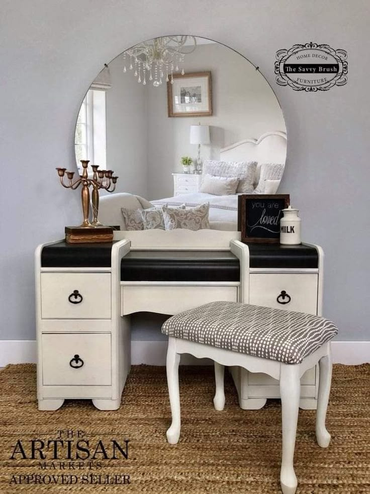 a white vanity with a mirror and stool in front of it on the carpeted floor