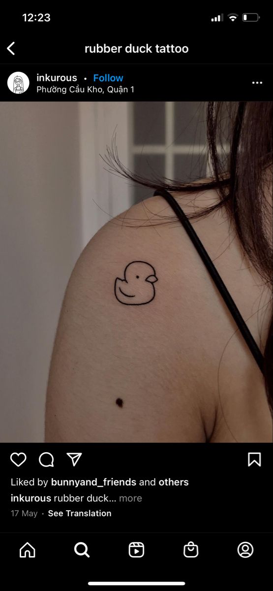 a woman's shoulder with a rubber duck tattoo on it