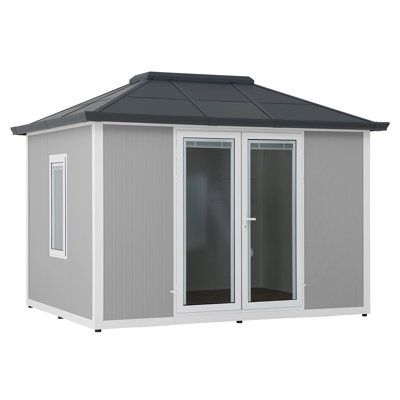 a small gray and white shed with sliding glass doors