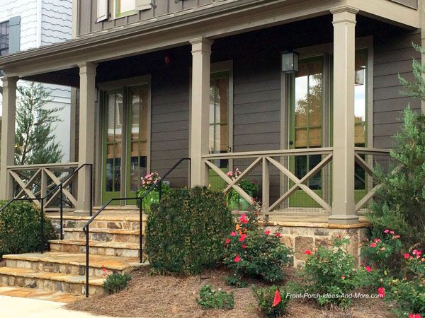 a house with steps leading up to the front door and flowers growing on the side