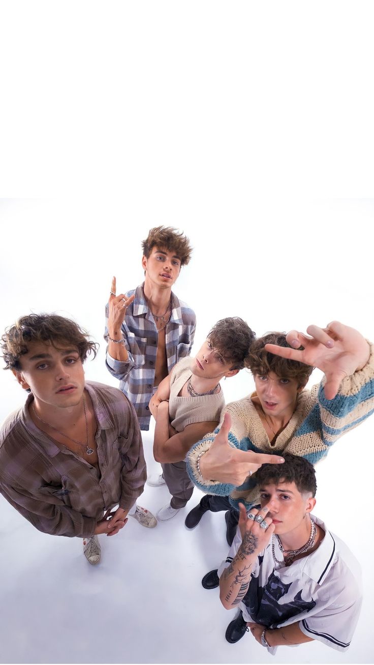 five young men posing in front of a white background with the words why don't we written on it