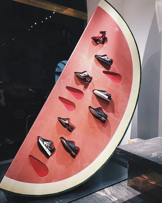 a watermelon that has shoes on it and is being displayed in front of an instagram