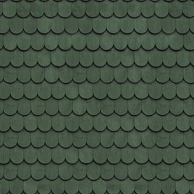 the roof of a house with dark gray shingles and black tile on it's sides