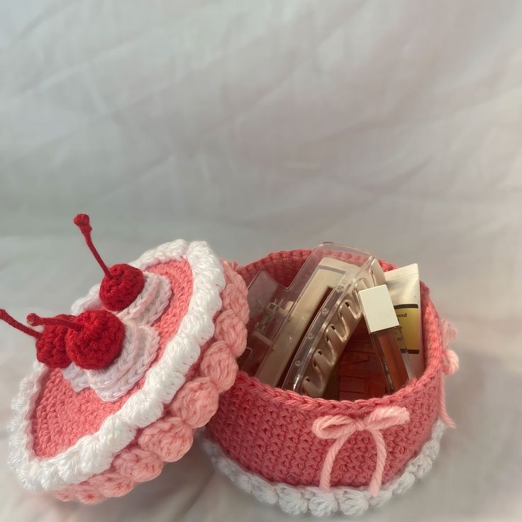 two crocheted baskets sitting on top of each other