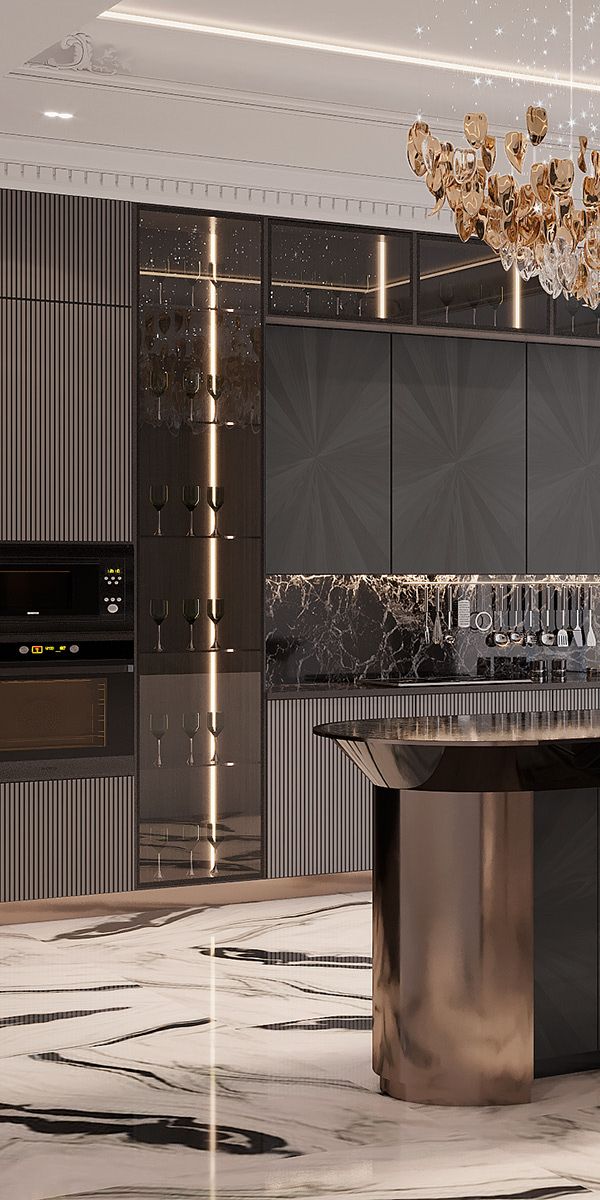 an elegant kitchen with marble counter tops and gold accents on the cabinets, along with a chandelier that hangs from the ceiling