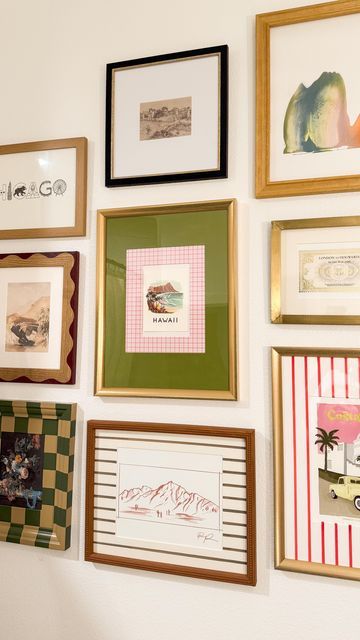 a wall with many framed pictures on it