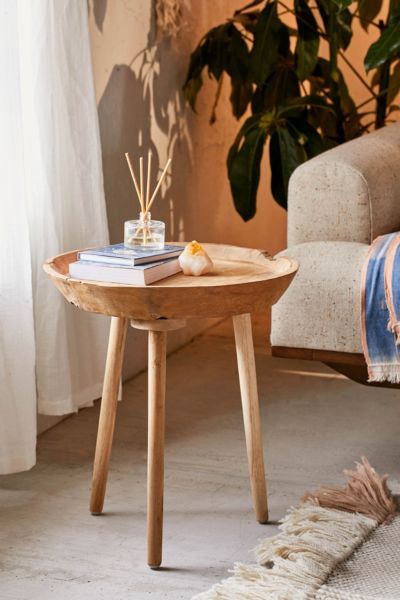 a small wooden table sitting on top of a rug