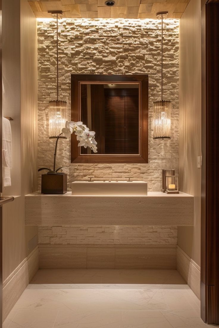 a bathroom with stone walls and lights on the ceiling, along with a large mirror