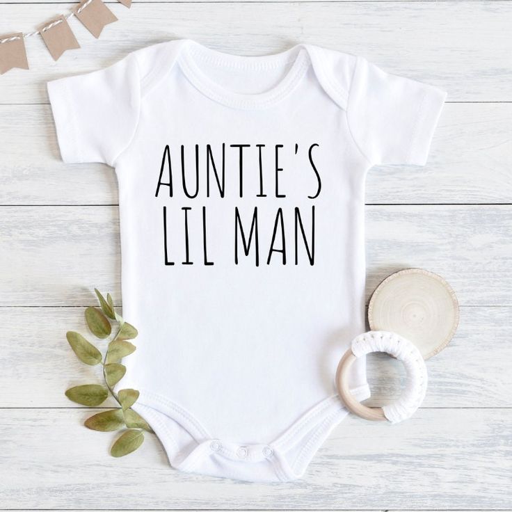 Aunties Little Man Baby Bodysuit, Aunt Pregnancy Announcement, Baby Gift From Aunt, Baby Shower Gift Boy, Baby Boy Outfit, Baby Boy Clothes 💗 Welcome to The MintedWildflower Etsy Shop! DESCRIPTION: An adorable baby bodysuit with softness that is perfect for an infant's sensitive, smooth skin. Durable print will survive the very first adventures of your little explorer. Celebrate your bundle of sunshine with this sweet bodysuit. This adorable piece is the perfect light layer for a baby. This pro Personalized White Bodysuit For First Birthday, White Personalized Bodysuit For First Birthday, White Bodysuit With Name Print For First Birthday, Aunt Onesie Boy, Onsies Ideas Boy, Baby Boy Onesies Vinyl, Auntie Onesies, Auntie Baby Clothes, Aunt Baby Clothes