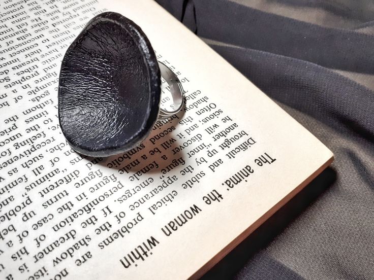 Black statement ring, unique modern jewelry, bohemian ring for women, boho black ring, adjustable band oval cocktail ring, modern leather jewelry.  One of a kind ring, abstract, chunky but lightweight. Made from black genuine leather. Wear it for a bold  modernist look.  A rare ring , a conversation starter. Such an unique gift for sister, mother, girlfriend. It's width is approximately 4,5 cm, the depth is 2,5 cm. Silver sturdy adjustable band. You may like this one big sculpted ring : https://www.etsy.com/uk/listing/971543430/large-real-leaf-leather-ring?_ga=2.79707346.477057164.1634229727-107141989.1595764951 For more cool rings see : https://www.etsy.com/uk/listing/1085649348/raw-crystal-amethyst-ring?ref=shop_home_active_2&frs=1 Black Statement Ring, Statement Rings Unique, Unique Gifts For Sister, Bohemian Ring, Leather Ring, Black Ring, Bohemian Rings, Ring Unique, Etsy Jewelry