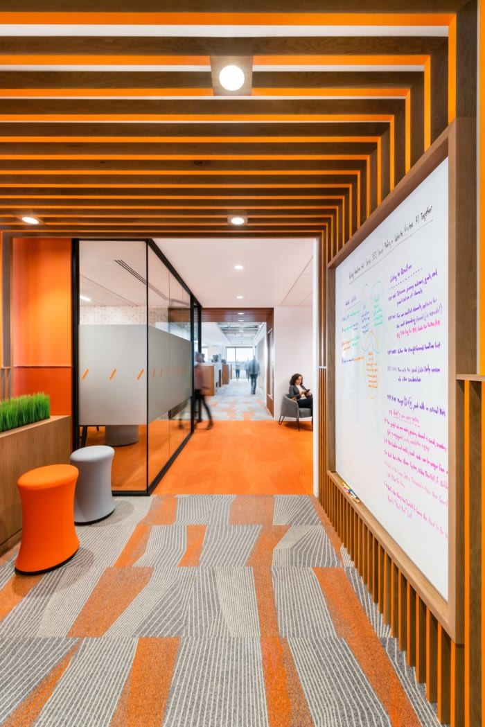 an office with orange and white walls and carpet