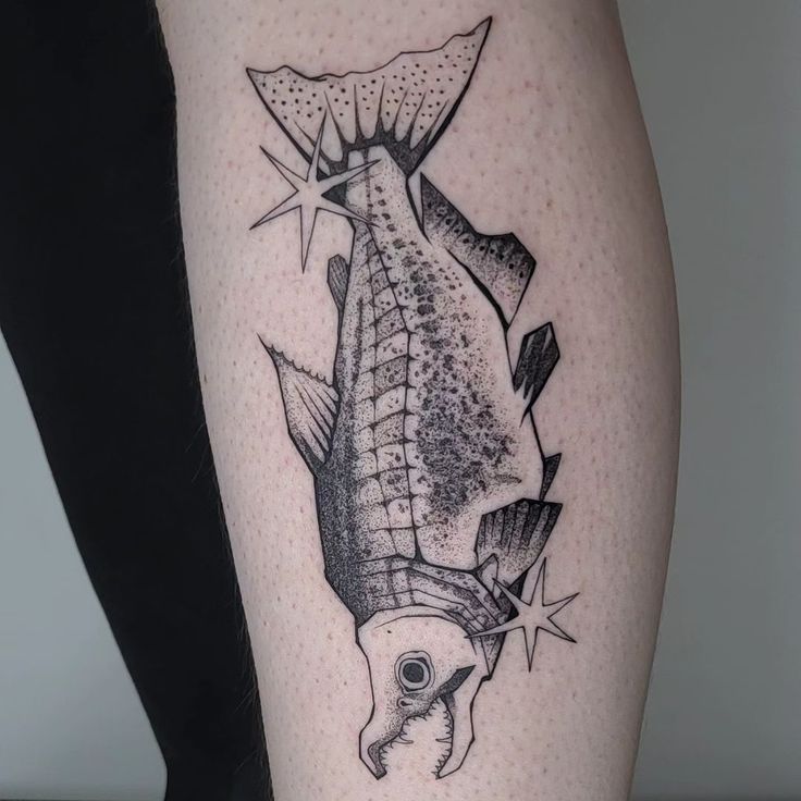 a black and white photo of a fish on the leg