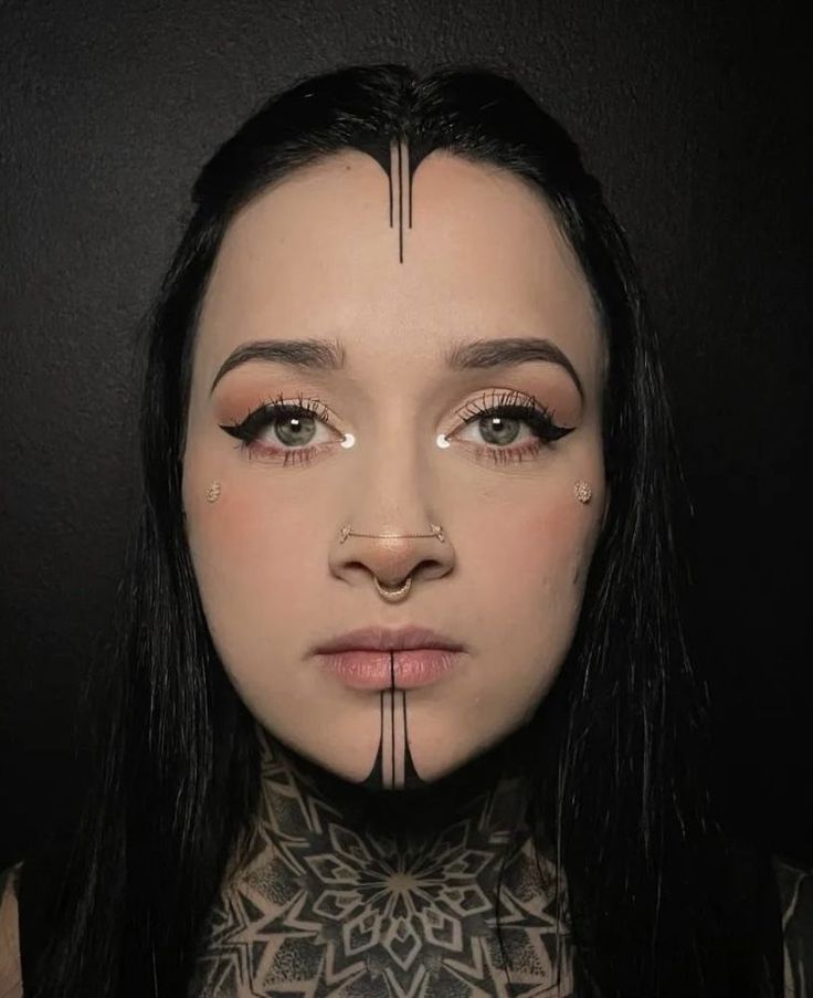 a woman with black hair and piercings on her neck is looking at the camera