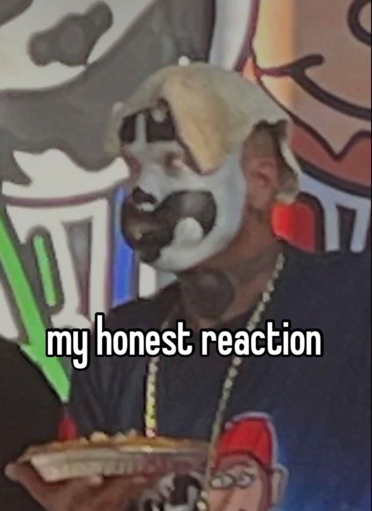 a man wearing a mask and holding a hot dog in front of him with the words my honest reaction