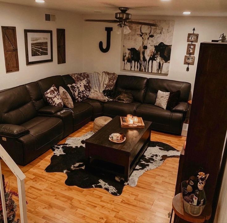 a living room filled with lots of furniture on top of a hard wood floored floor