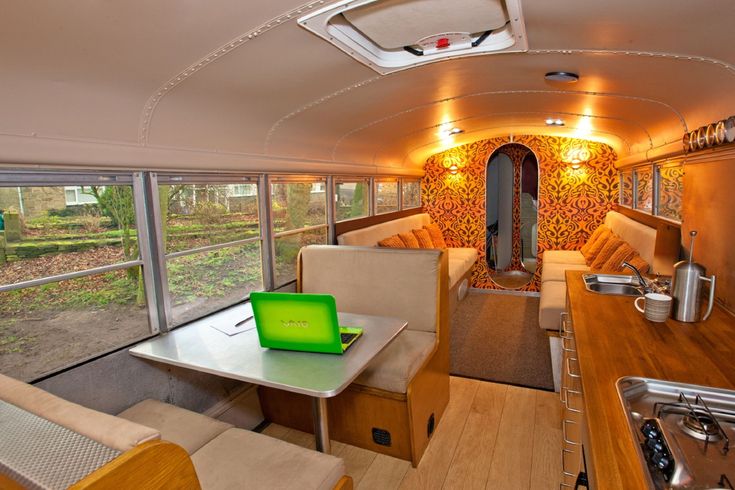 the interior of an rv with tables and chairs