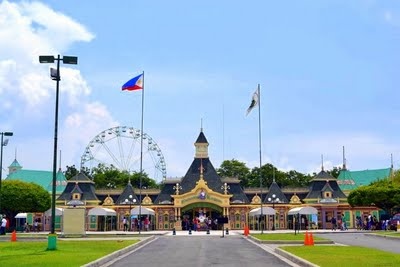 a large building with a ferris wheel in the background