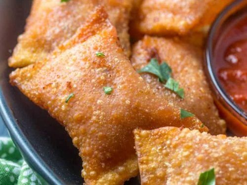 some fried food is on a plate with dipping sauce