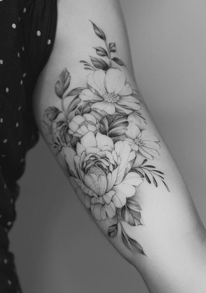 a woman's arm with flowers on it