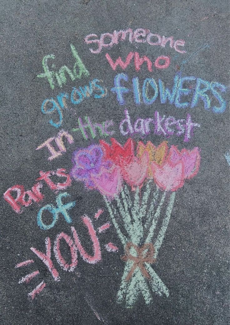 someone wrote flowers in chalk on the sidewalk