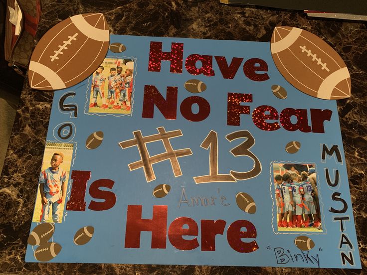 there is a sign that says have no fear and has pictures of footballs on it