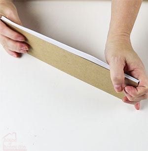 a person is holding a piece of cardboard