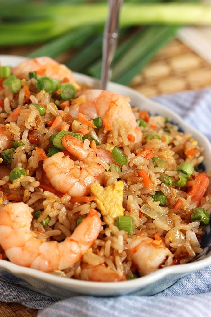 a bowl filled with shrimp and rice on top of a table