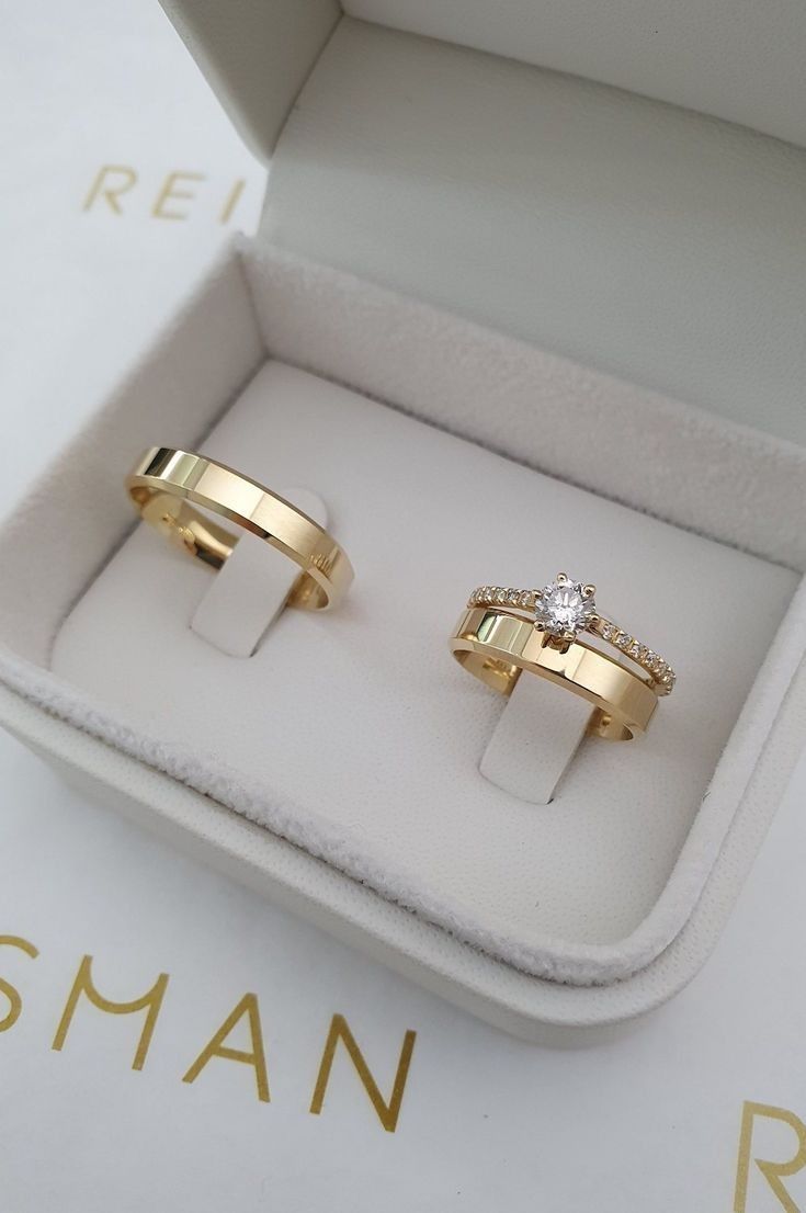 two gold wedding rings in a box