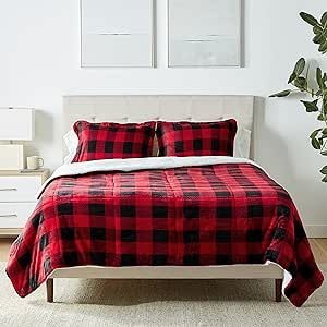 a red and black plaid comforter set on a bed