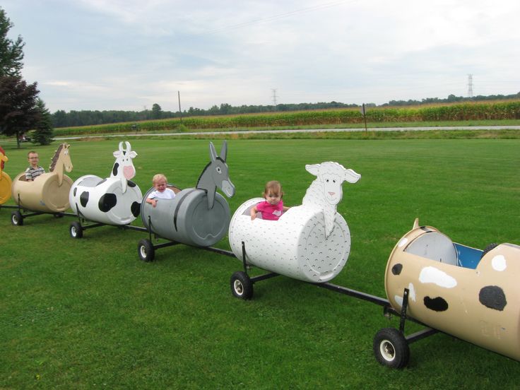 children are riding on an inflatable animal train