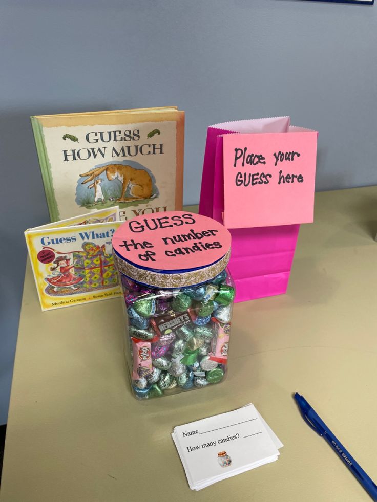 there are many books and candy in the jar on the table with it's name