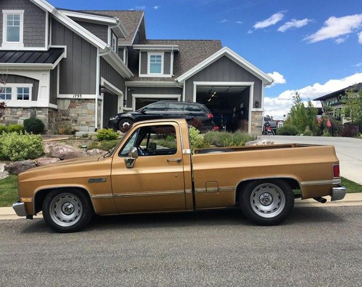 a brown truck parked in front of a house