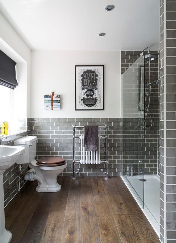 a bathroom with grey tiles and white fixtures