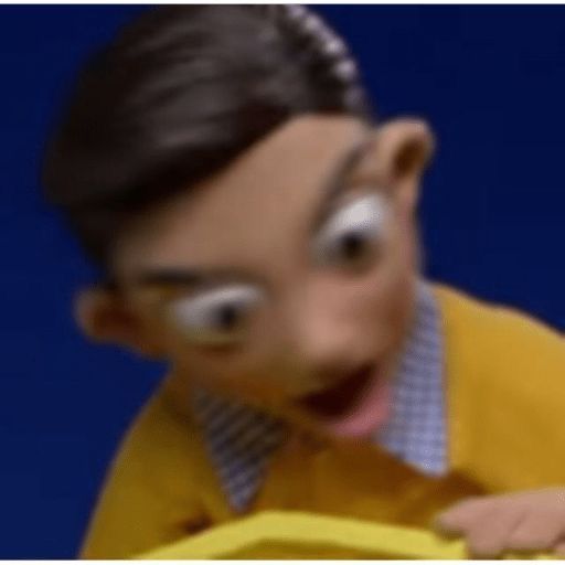 a young boy wearing a yellow sweater and tie with his mouth open while holding a banana in front of him