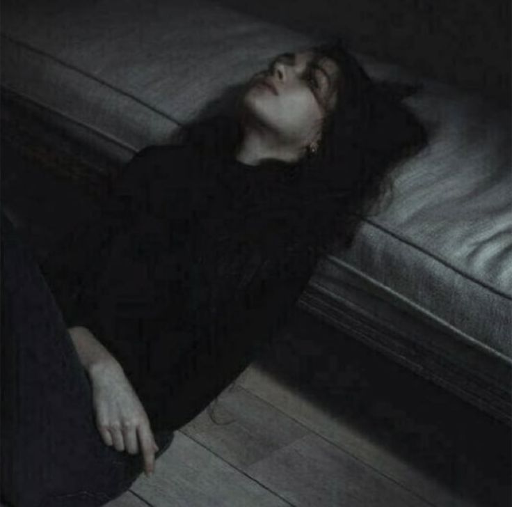 a woman laying on the floor with her eyes closed